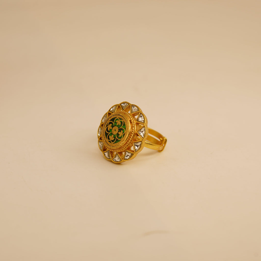 Gold ring with decorative design on a beige background